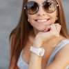 Beautiful happy girl with a white smile wearing summer colored clothes with fashion sunglasses Beautiful happy girl with a white smile wearing summer colored clothes with fashion sunglasses