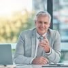 Senior business man, portrait and smile in office at corporate company for testimonial and motivati Equipo profesional de limpieza en Mataró realizando servicios a domicilio